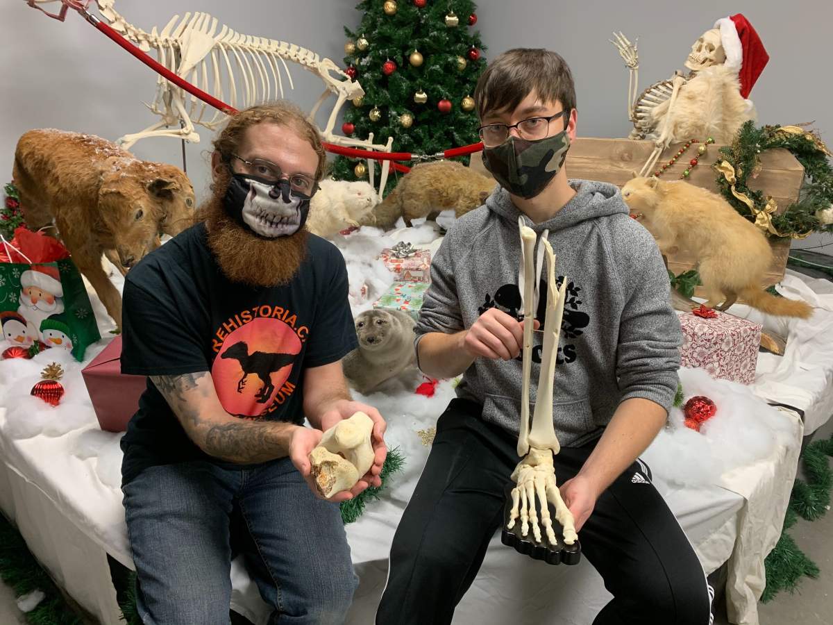 Ben Levatt (left) and Justin Fernandes (right) show the bones that made up Fernandes’ right leg.