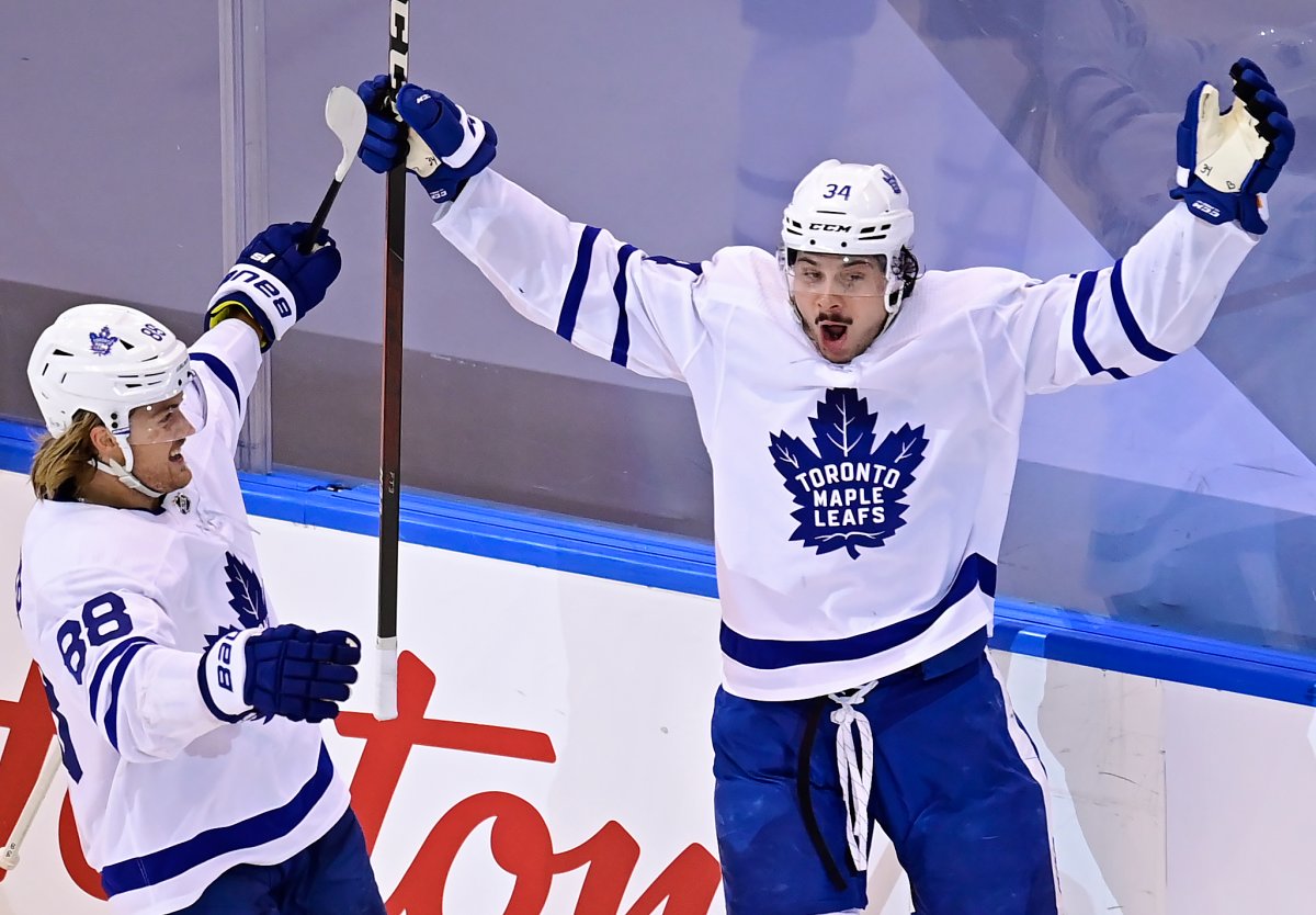 Toronto Maple Leafs' Auston Matthews (34) celebrates his game winning goal against the Columbus Blue Jackets with teammate William Nylander (88) during overtime NHL Eastern Conference Stanley Cup playoff action in Toronto on Friday, August 7, 2020.
