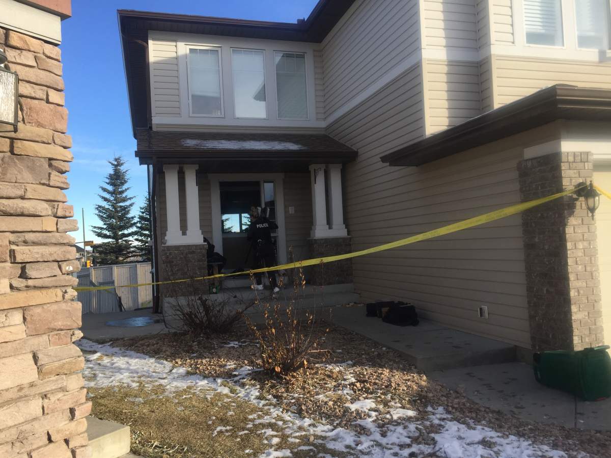 Police tape is seen surrounding a home in Panorama Hills where a man was found stabbed to death on Wednesday, Dec. 16.