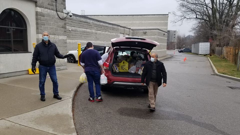 Volunteers loading food donations into a van on Sun. Dec. 20, 2020 at the London Muslim Mosque's drive thru food drive.