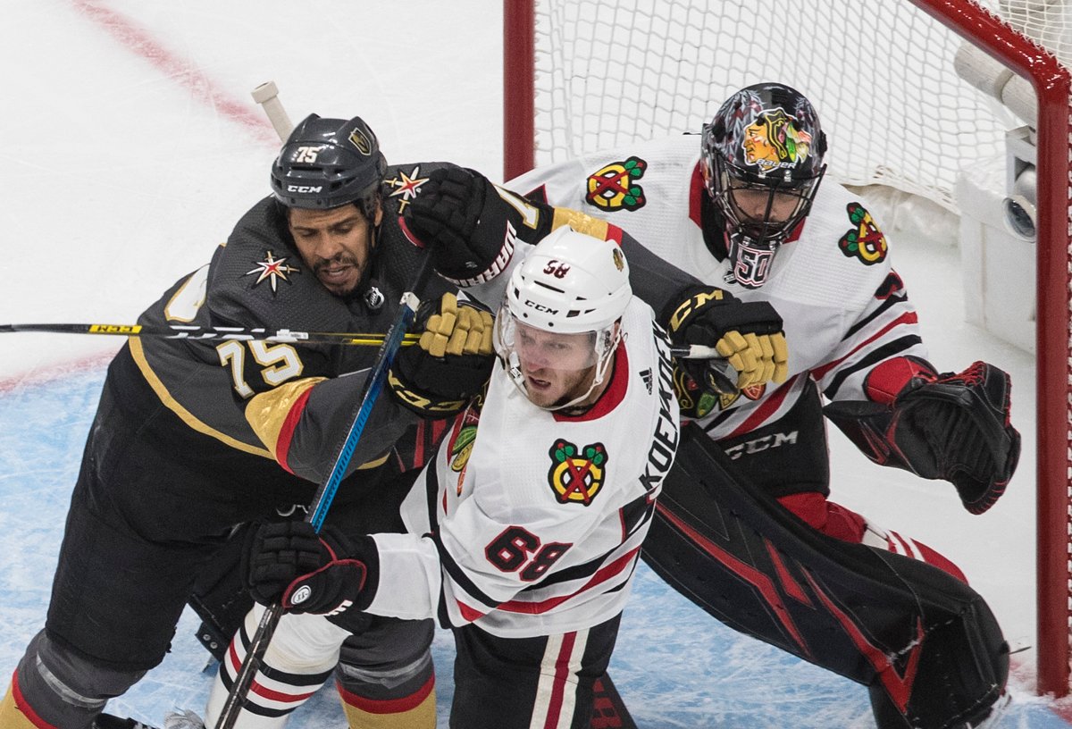 Chicago Blackhawks' Slater Koekkoek (68) and Vegas Golden Knights' Ryan Reaves (75) battle in front of Blackhawks goalie Corey Crawford (50) during the second period of a first round NHL Stanley Cup playoff hockey series in Edmonton, on Tuesday August 11, 2020. THE CANADIAN PRESS/Jason Franson.