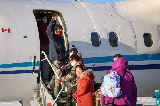 Neskantaga First Nation residents board a plane to return home from Thunder Bay on Dec. 19, 2020, following a two month evacuation that was triggered by problems at their drinking water treatment plant.