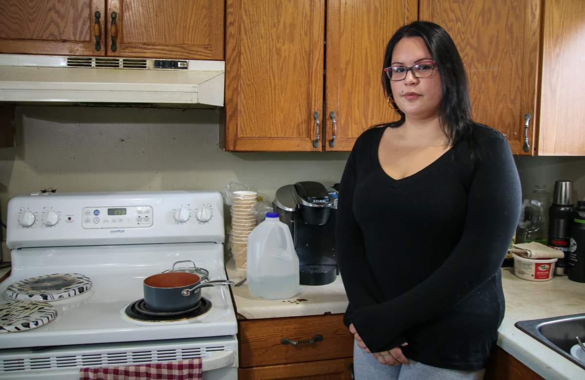 Charla Moonias prepares tea in the kitchen in her home on Nesktanaga First Nation, Ont. on December 19, 2020. Moonias said she’s frustrated at delay in resolving the 25-year boil water advisory in her community.