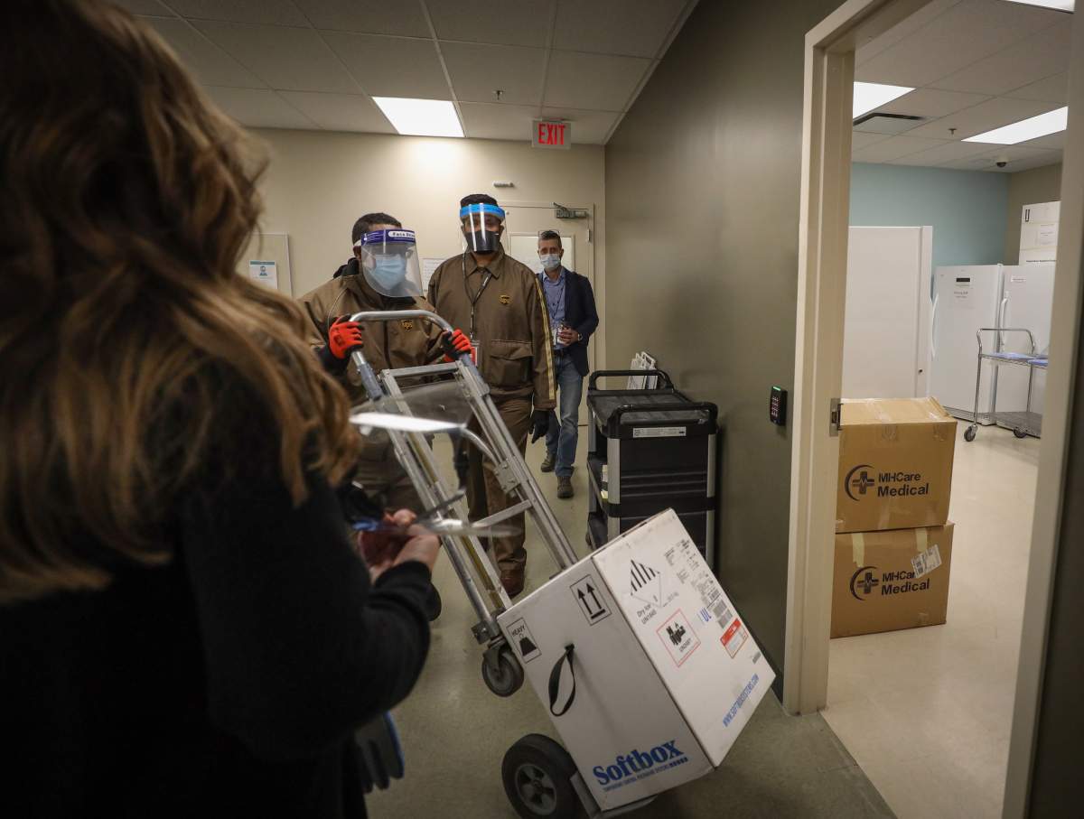 The first shipment of the Pfizer-BioNTech COVID-19 vaccine is unloaded and put into an ultra-cold storage unit at a Calgary vaccination site on the morning of Tuesday, December 15, 2020