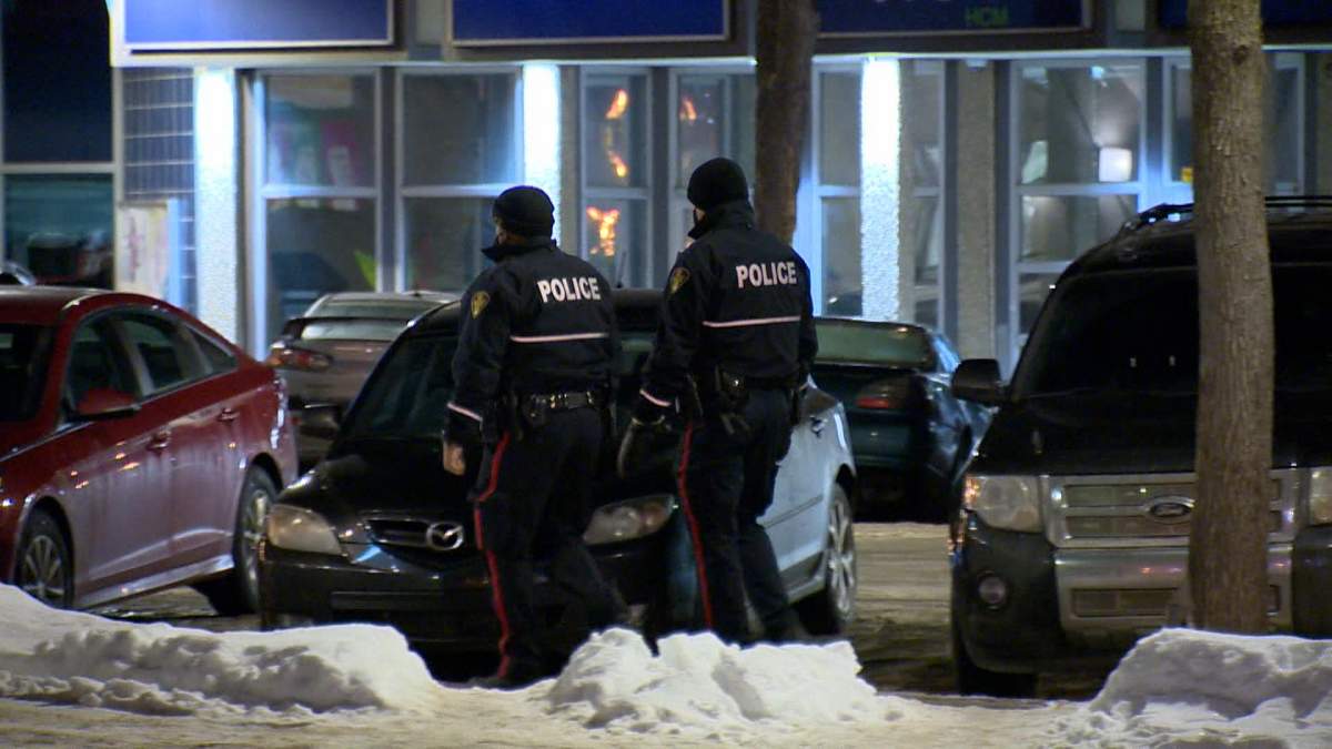 Police officers walking through downtown Saskatoon.