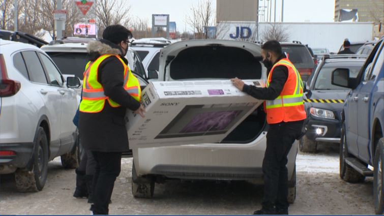 Best Buy curbside pickup order being loaded into a customers trunk in Winnipeg, MB.