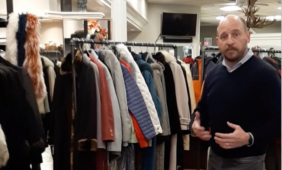 Rob Cahill standing in front of more than 200 donated coats for the recent No Cold Shoulders campaign in Peterborough.
