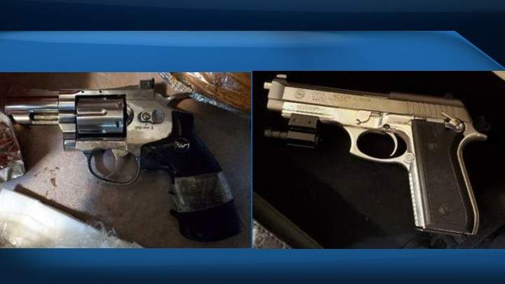 Officers say they seized two handguns, one of which was loaded.