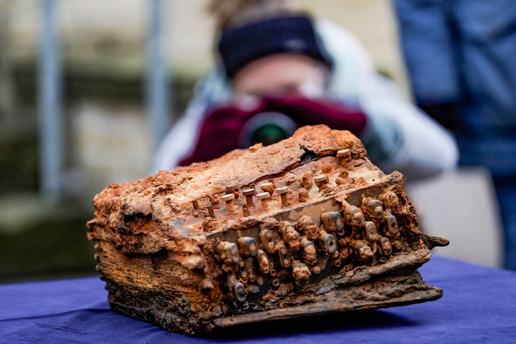The Enigma cipher machine found in the Baltic Sea is shown lying on a table in front of the archaeological office of Schleswig-Holstein. 
