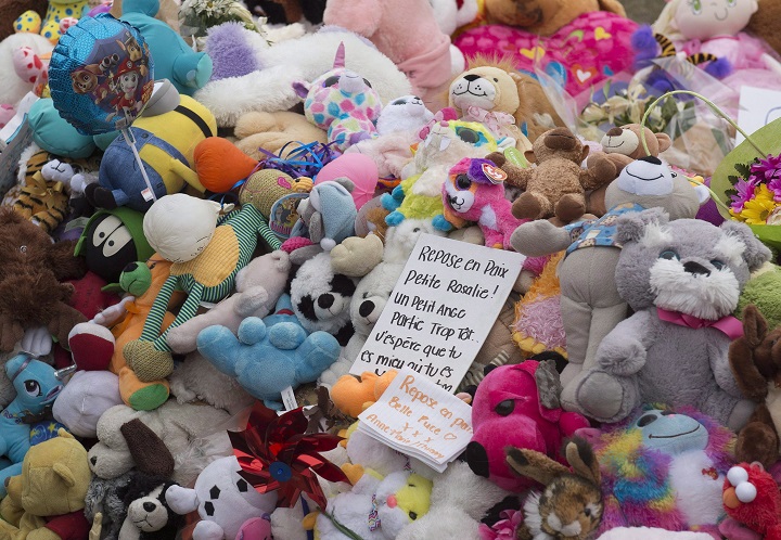 A message is set in the middle of a pile of plush toys before a silent march to commemorate the tragic death of two-year-old Rosalie Gagnon, Tuesday, April 24, 2018 in Quebec City.