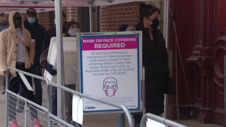 A sign advises people to wear face masks at the St. Lawrence Market in Toronto during the coronavirus pandemic.