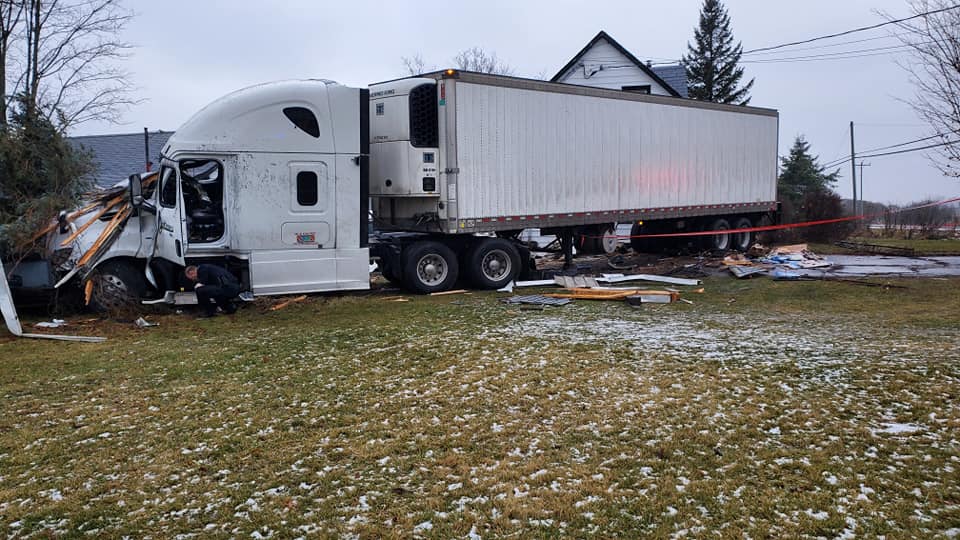 A transport truck sitting at rest that struck a home in Belleville