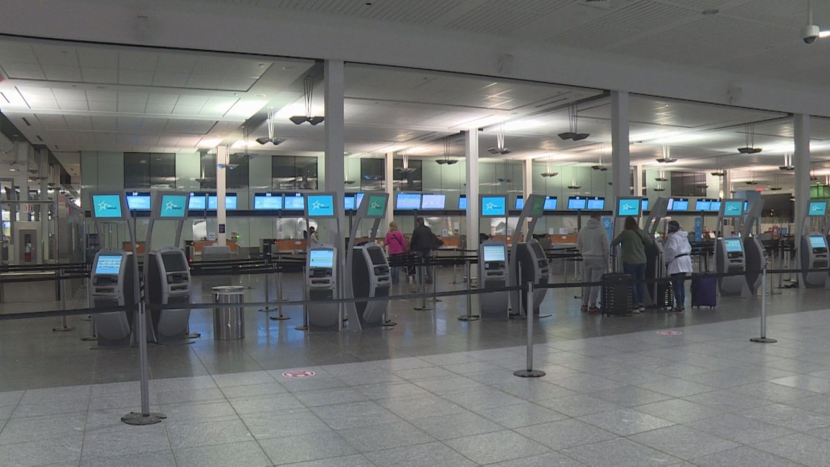Montrealers check in for a trip to Mexico Thursday morning. Dec 24, 2020.