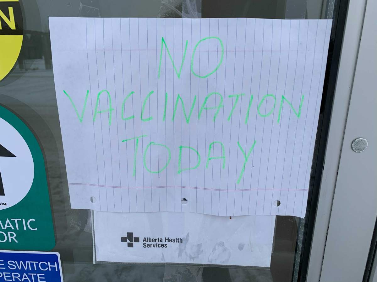 Sign on the door of a AHS COVID-19 vaccination clinic in south Edmonton on Wednesday, Jan. 27, 2021.