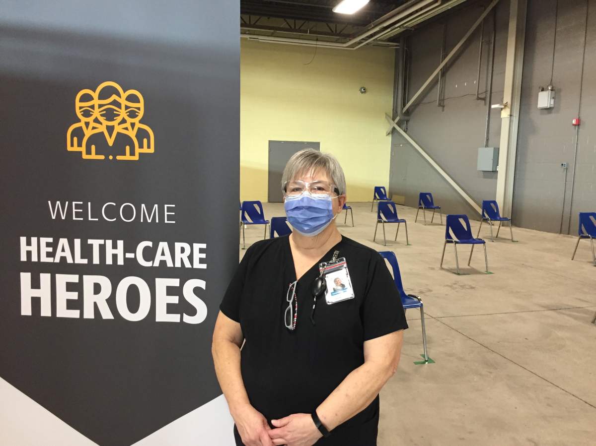 71-year-old retired Beth Shields working at the coronavirus vaccine clinic at the Western Fair District Agriplex in London Ont.