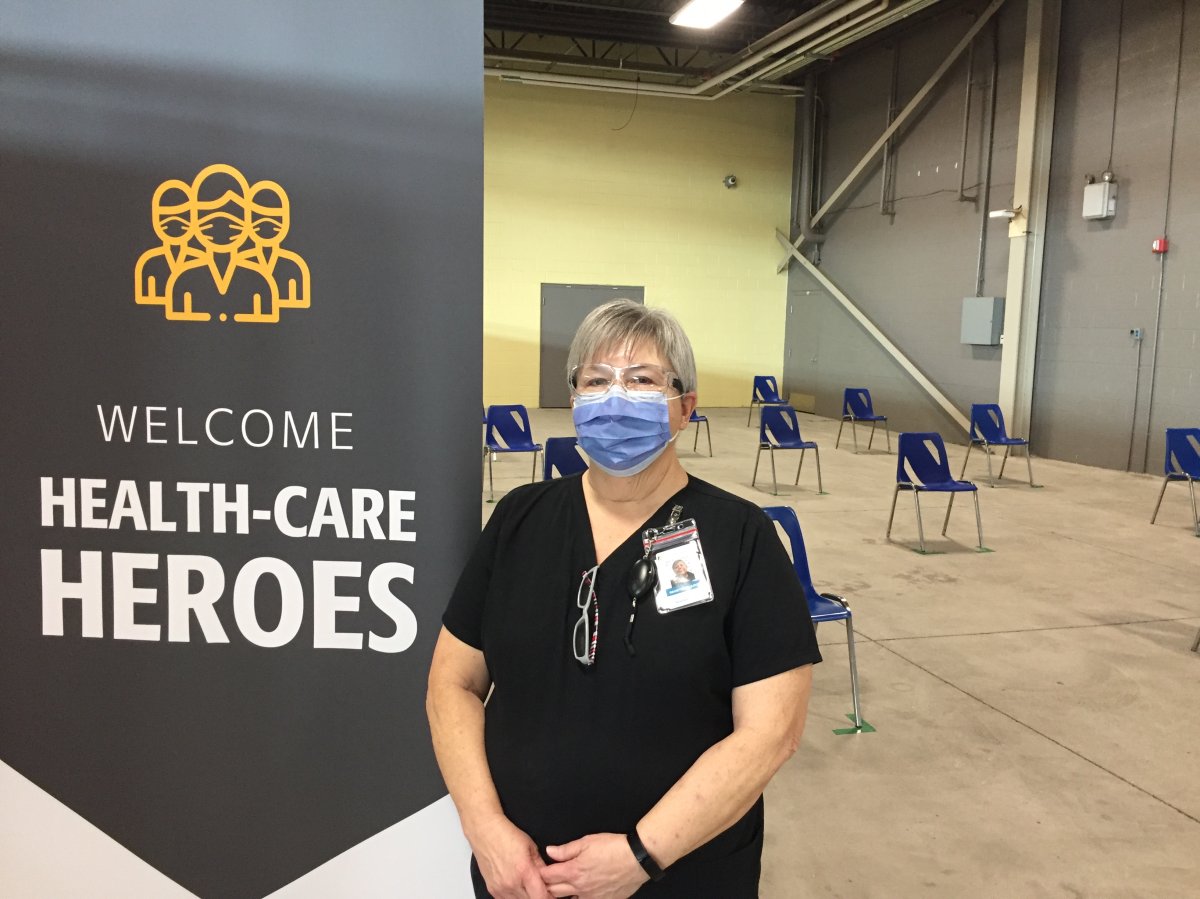 71-year-old retired Beth Shields working at the coronavirus vaccine clinic at the Western Fair District Agriplex in London Ont.