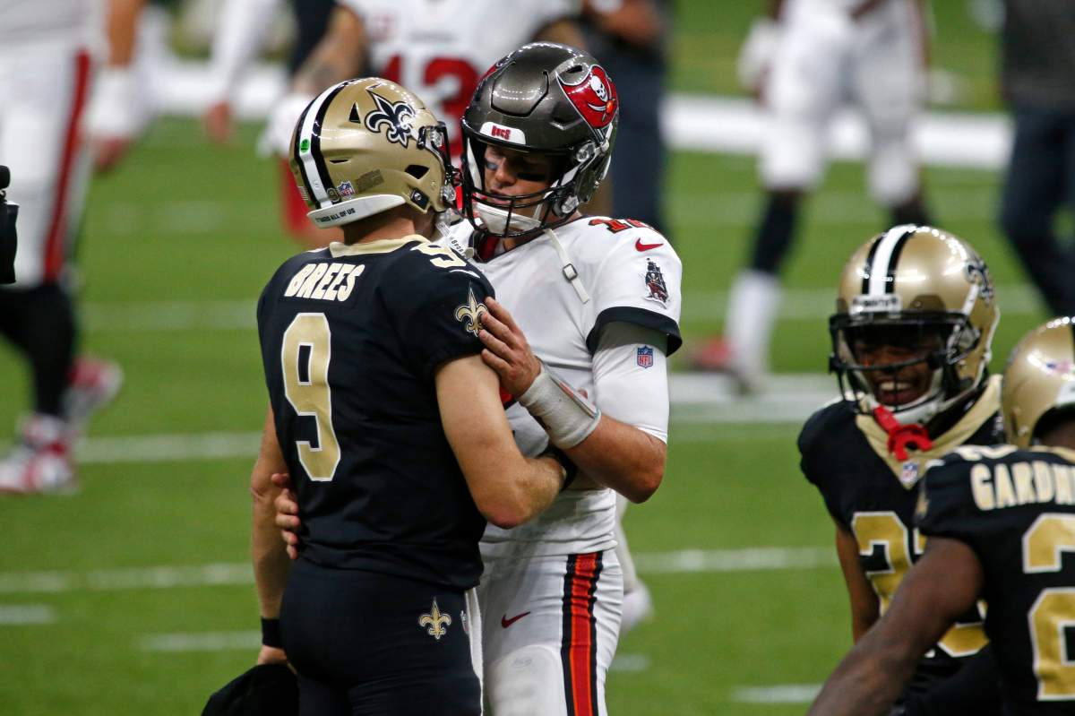 New Orleans Saints quarterback Drew Brees (9) and Tampa Bay Buccaneers quarterback Tom Brady hug after their season opening NFL football game in New Orleans, Sunday, Sept. 13, 2020. The Saints won 34-23.