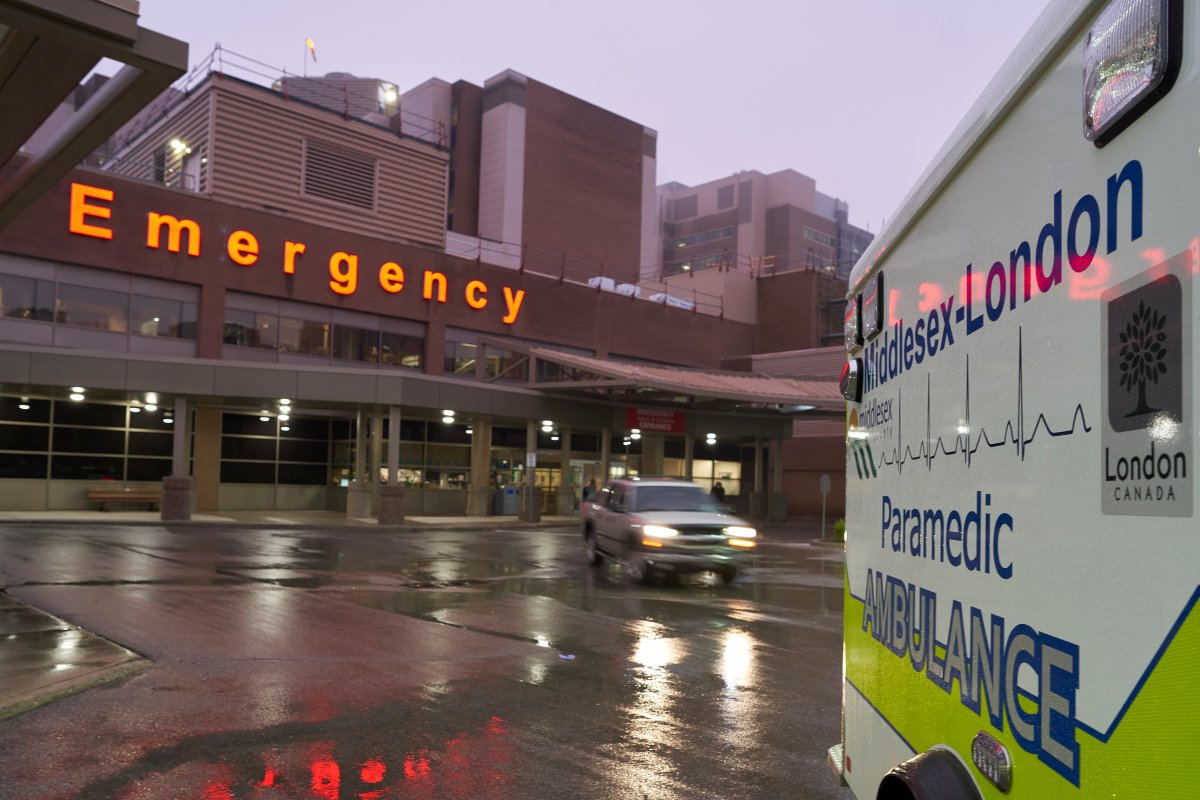 FILE - Ambulances sit in front of the emergency department at Victoria Hospital in London, Ont., on Wednesday, Nov. 25, 2020.