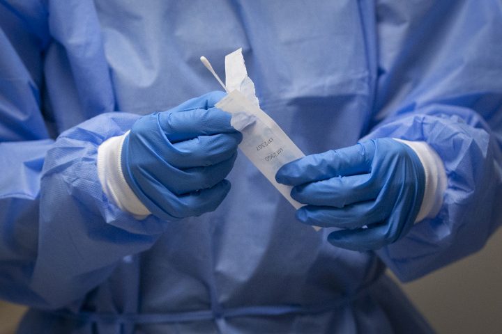 A pharmacist holds a COVID-19 test swab at a pharmacy in Amherstview, Ontario on Friday, January 22, 2021, as the COVID-19 pandemic continues across Canada and around the world. 