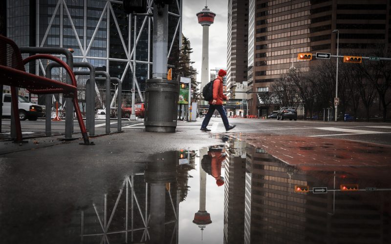 A pedestrian wearing a mask walks through an empty downtown Calgary, Alta., Wednesday, Dec. 9, 2020,.