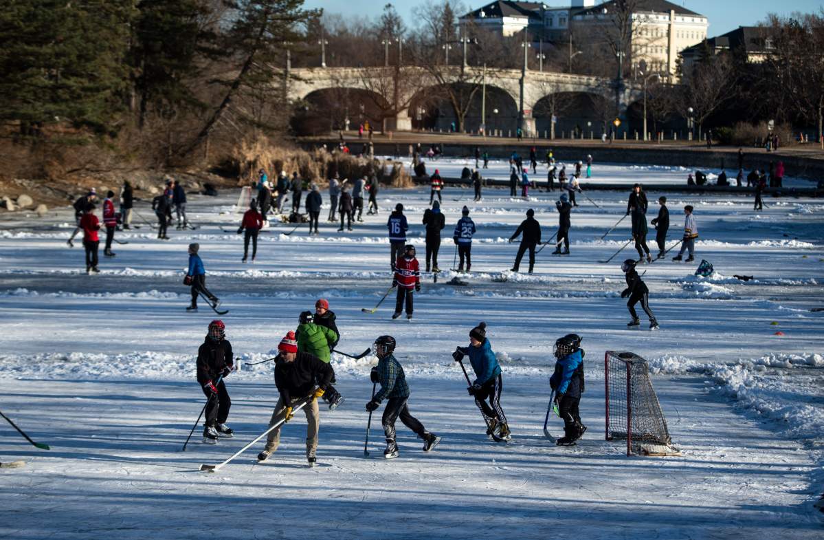 People play pond hockey on Brown's Inlet in Ottawa, on Tuesday, Dec. 29, 2020. 
