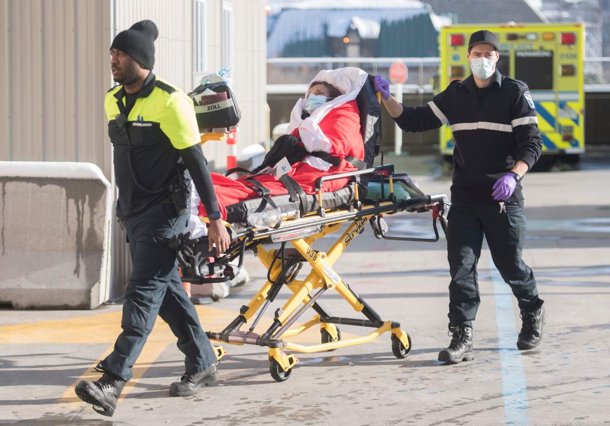 Paramedics transfer a woman into a hospital in Montreal, Saturday, January 2, 2021, as the COVID-19 pandemic continues in Canada and around the world. 
