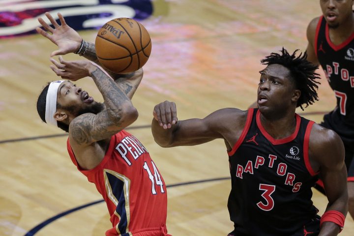 New Orleans Pelicans forward Brandon Ingram (14) loses the ball as he drives to the basket with Toronto Raptors forward OG Anunoby (3) defending during the second half of an NBA basketball game on Saturday, Jan. 2, 2021, in New Orleans.