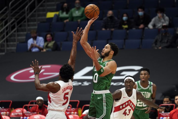 Boston Celtics forward Jayson Tatum (0) shoots over Toronto Raptors forward Stanley Johnson (5) during the first half of an NBA basketball game Monday, Jan. 4, 2021, in Tampa, Fla.