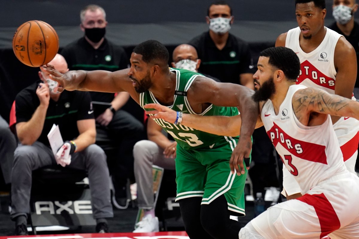 Boston Celtics center Tristan Thompson (13) and Toronto Raptors guard Fred VanVleet (23) chase a loose ball during the second half of an NBA basketball game Monday, Jan. 4, 2021, in Tampa, Fla. 
