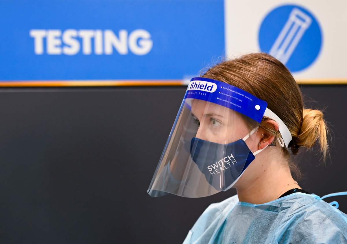Hailey Knott, nurse operations manager, waits at a COVID-19 testing station located at the international arrivals area at Pearson International Airport in Toronto on Wednesday, Jan. 6, 2021.