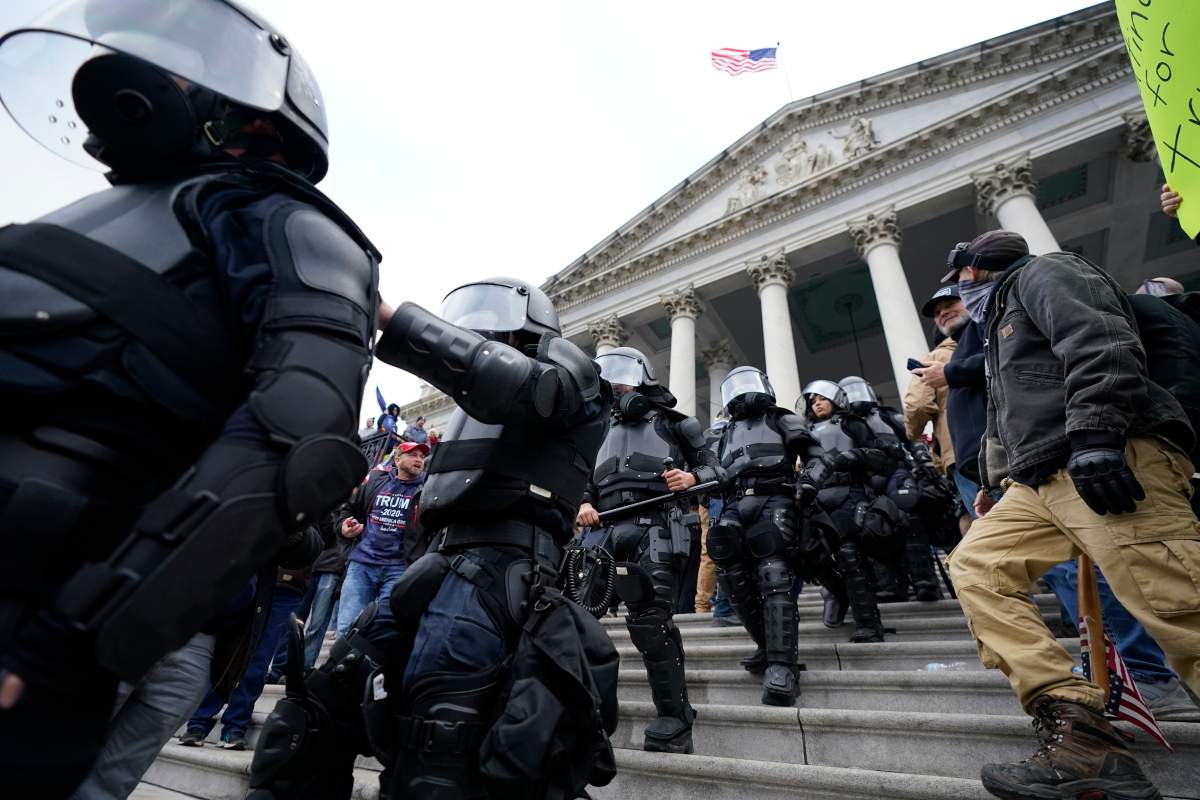 Police in riot gear walk out of the Capitol, Wednesday, Jan. 6, 2021, in Washington. – AP Photo/Manuel Balce Ceneta