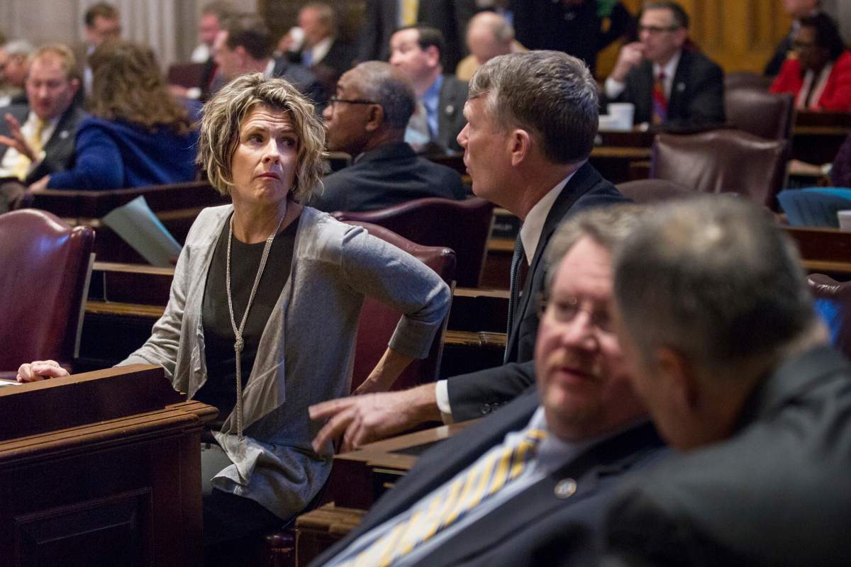 FILE - In this Thursday, Feb. 16, 2017 file photo, Rep. Terri Lynn Weaver, R-Lancaster, left, and Rep. John Mark Windle, D-Livingston, confer during a House floor session in Nashville, Tenn.