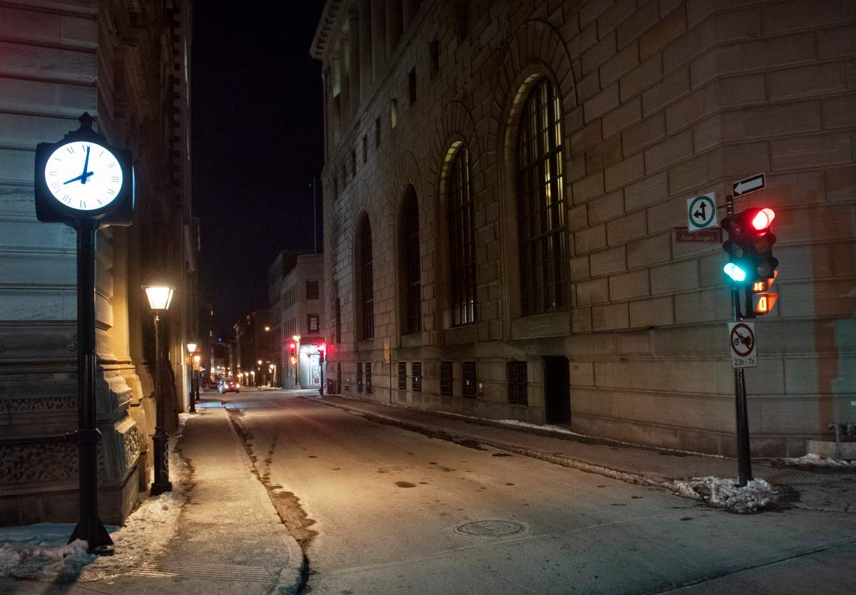 A clock reading 8 p.m is shown on the corner of an empty street in Montreal, Saturday, January 9, 2021, as the COVID-19 pandemic continues in Canada and around the world. The Quebec government has imposed a curfew to help stop the spread of COVID-19 starting at 8 p.m until 5 a.m and lasting until February 8. 