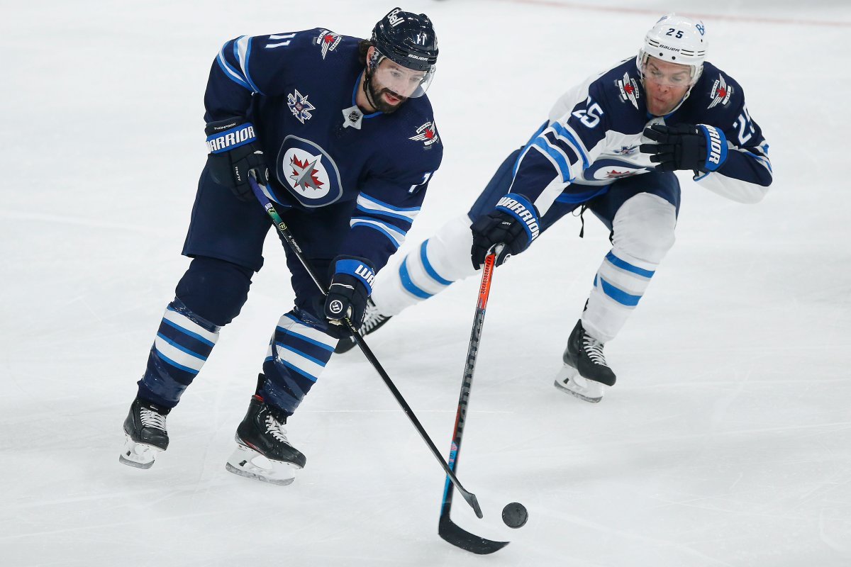 Winnipeg Jets' Paul Stastny (25) defends against Nate Thompson (11) during their NHL training camp scrimmage in Winnipeg, Monday, January 11, 2021. 