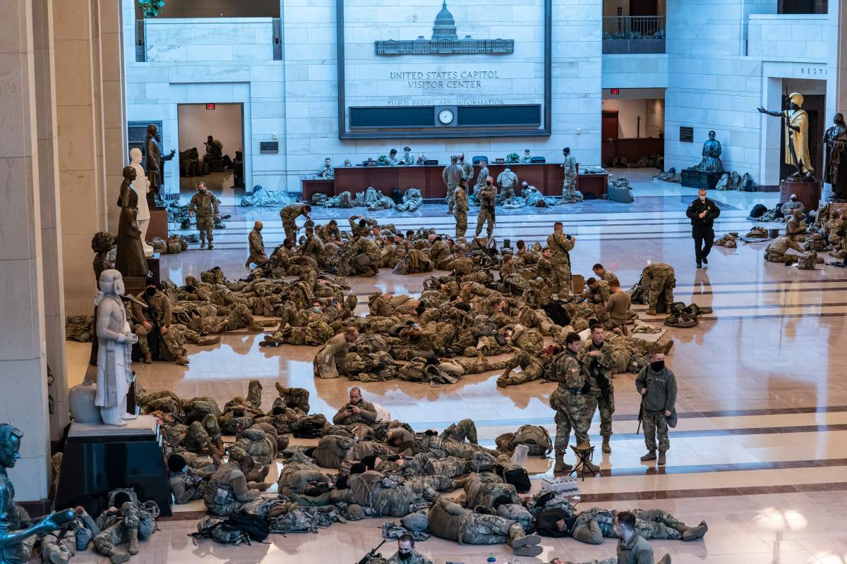 Hundreds of National Guard troops hold inside the Capitol Visitor’s Center to reinforce security at the Capitol in Washington, Wednesday, Jan. 13, 2021. The House of Representatives is pursuing an article of impeachment against President Donald Trump for his role in inciting an angry mob to storm the Capitol last week. (AP Photo/J. Scott Applewhite