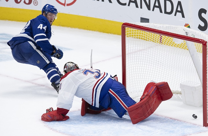 Toronto Maple Leafs defenceman Morgan Rielly (44) scores the game winning goal on Montreal Canadiens goaltender Carey Price (31) during overtime NHL action in Toronto, Wednesday, Jan. 13, 2021. THE CANADIAN PRESS/Frank Gunn.