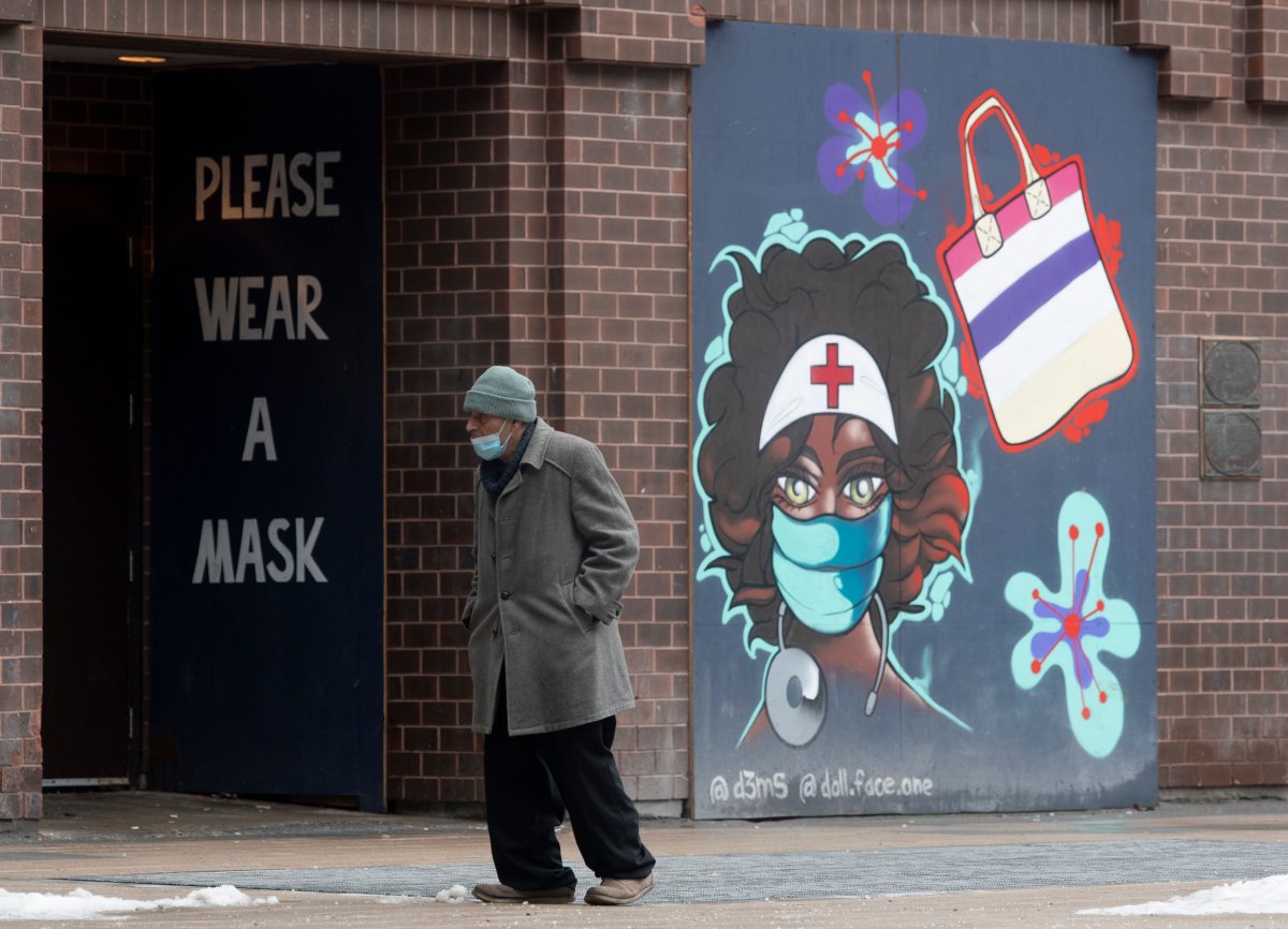 A man walks past murals in downtown Ottawa, Thursday January 14, 2021. 