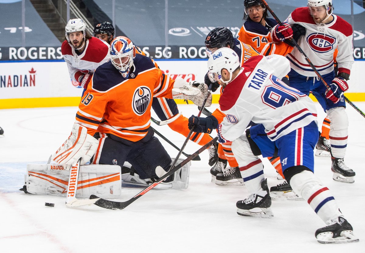 Edmonton Oilers goalie Mikko Koskinen (19) makes the save on Montreal Canadiens' Tomas Tatar (90) during first period NHL action in Edmonton on Saturday, January 16, 2021. THE CANADIAN PRESS/Jason Franson.