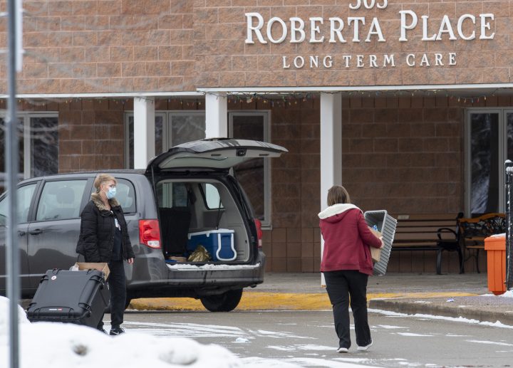 Workers arrive at the Roberta Place Long-Term Care home in Barrie on Monday, Jan. 18, 2021. The home has seen an outbreak of what's believed to be the U.K. COVID-19 variant among staff and residents.