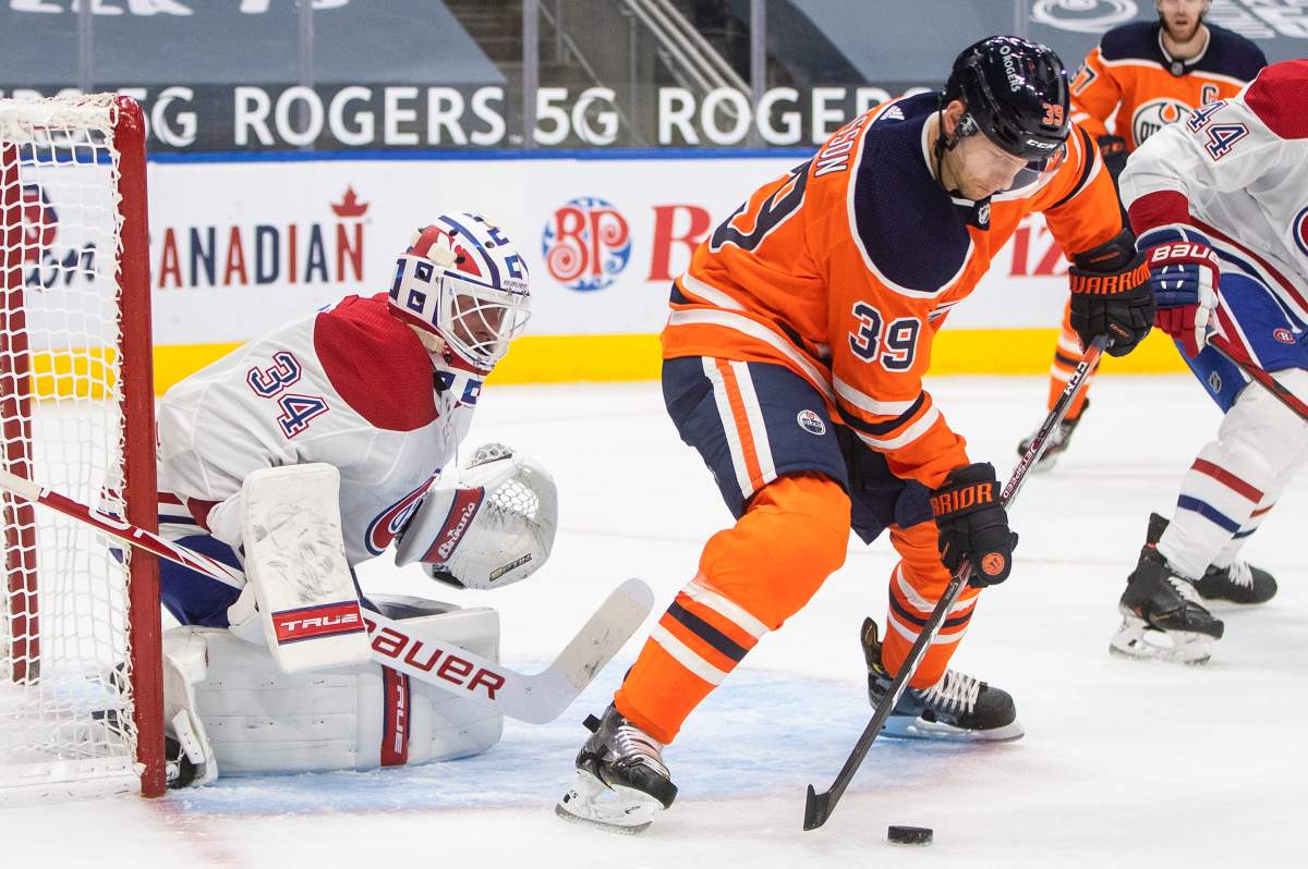 Edmonton Oilers' Alex Chiasson (39) tries to tip the puck in past Montreal Canadiens goalie Jake Allen (34) during second period NHL action in Edmonton on Monday, January 18, 2021.