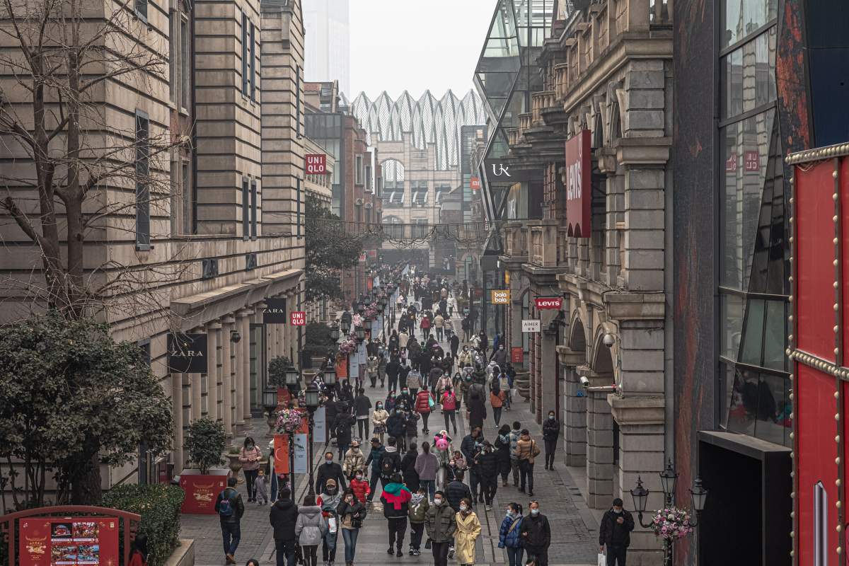 People walk at a shopping center on the day of Wuhan’s lockdown one-year anniversary, in Wuhan, China, January, 23 2021. EPA/ROMAN PILIPEY