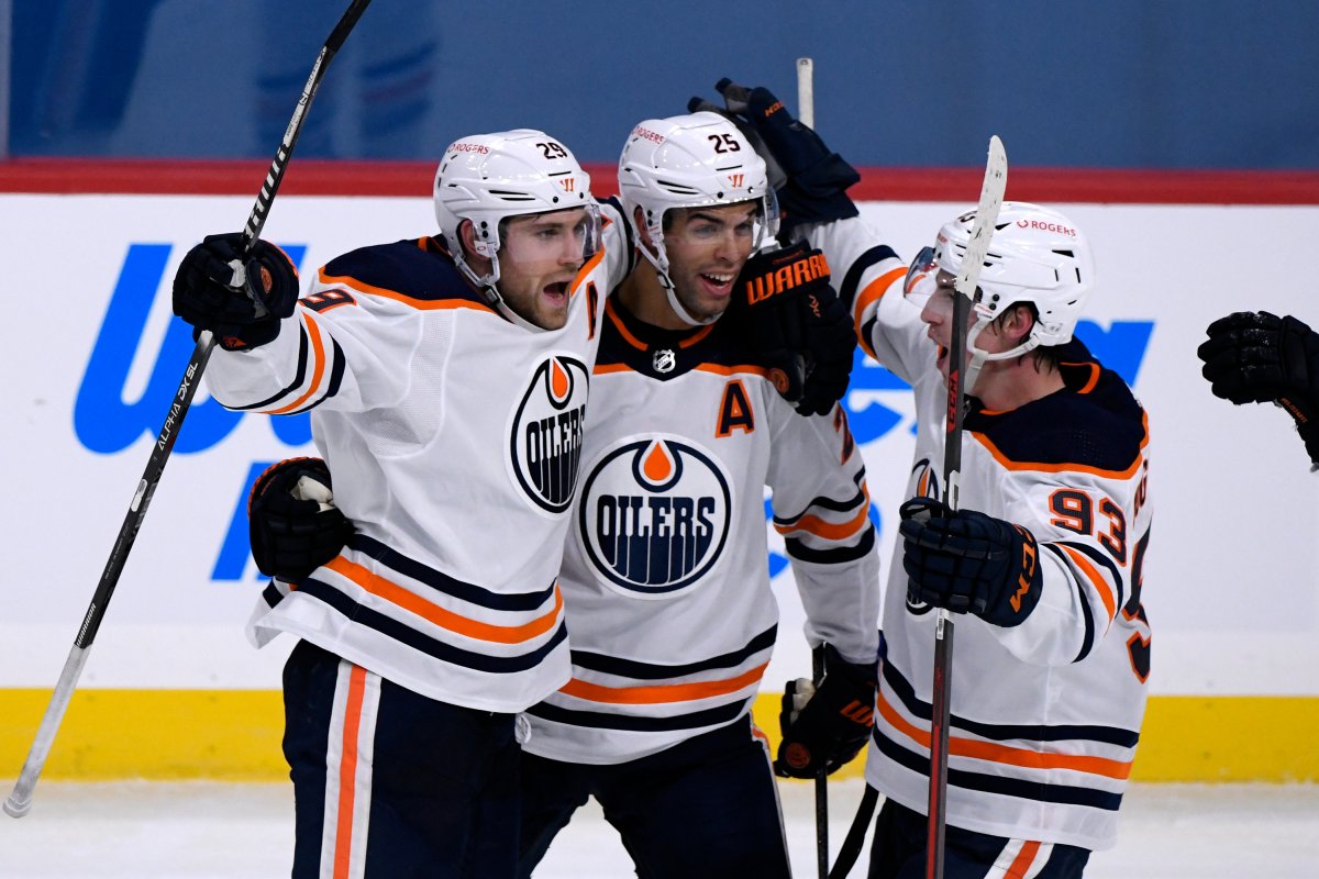 Edmonton Oilers' Leon Draisaitl (29) celebrates his game-winning goal against the Winnipeg Jets with teammates Darnell Nurse (25) and Ryan Nugent-Hopkins (93) during third period NHL action in Winnipeg on Sunday Jan. 24, 2021. THE CANADIAN PRESS/Fred Greenslade.