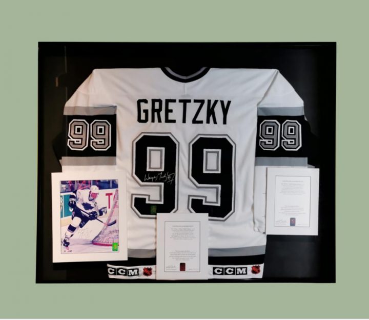 A Wayne Gretzky Los Angeles Kings jersey and signed photograph is shown in a handout from Ripley Auctions. A jersey, puck and stick signed by hockey legend Gretzky are among Ontario museum items up for auction.