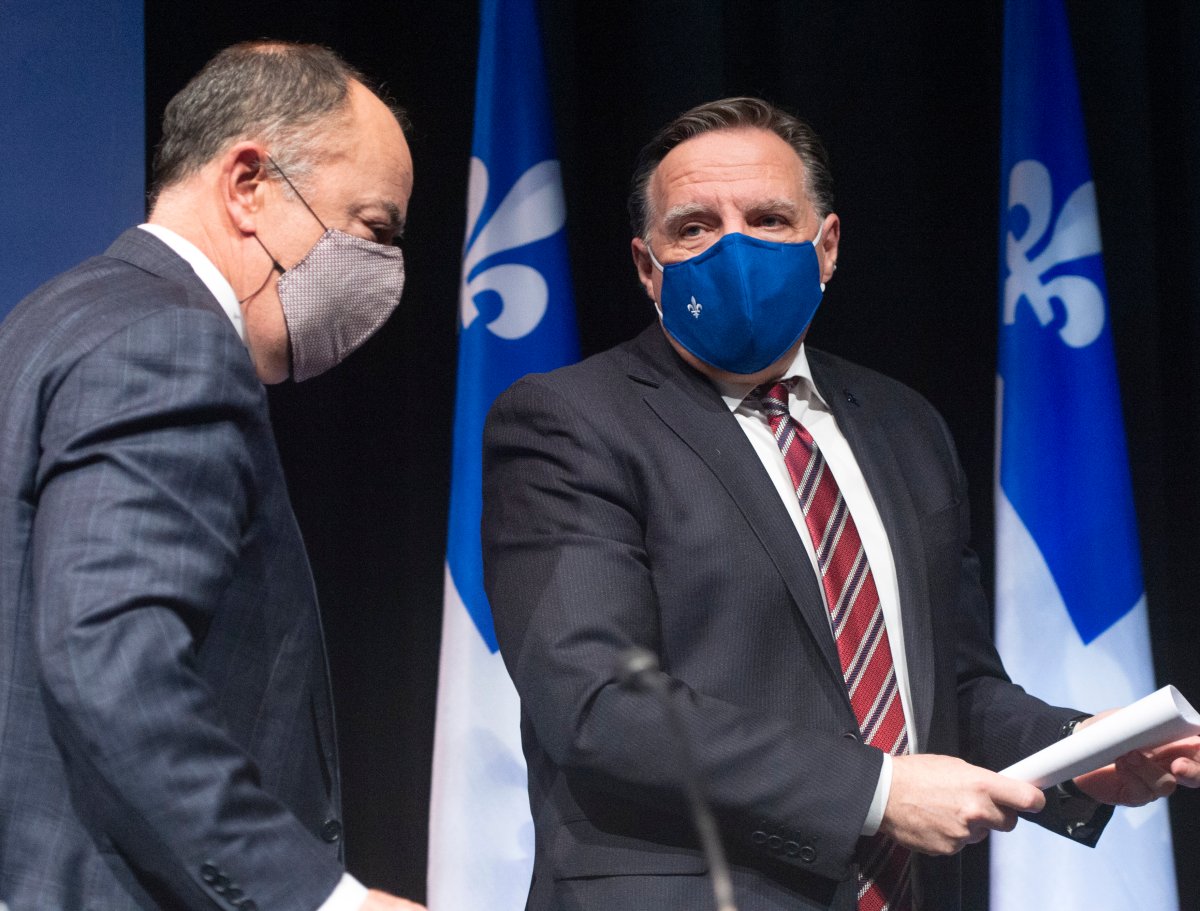 Quebec Premier Francois Legault, right, has a word with Health Minister Christian Dube as the leave the COVID-19 press briefing, Tuesday, January 26, 2021 in Montreal.