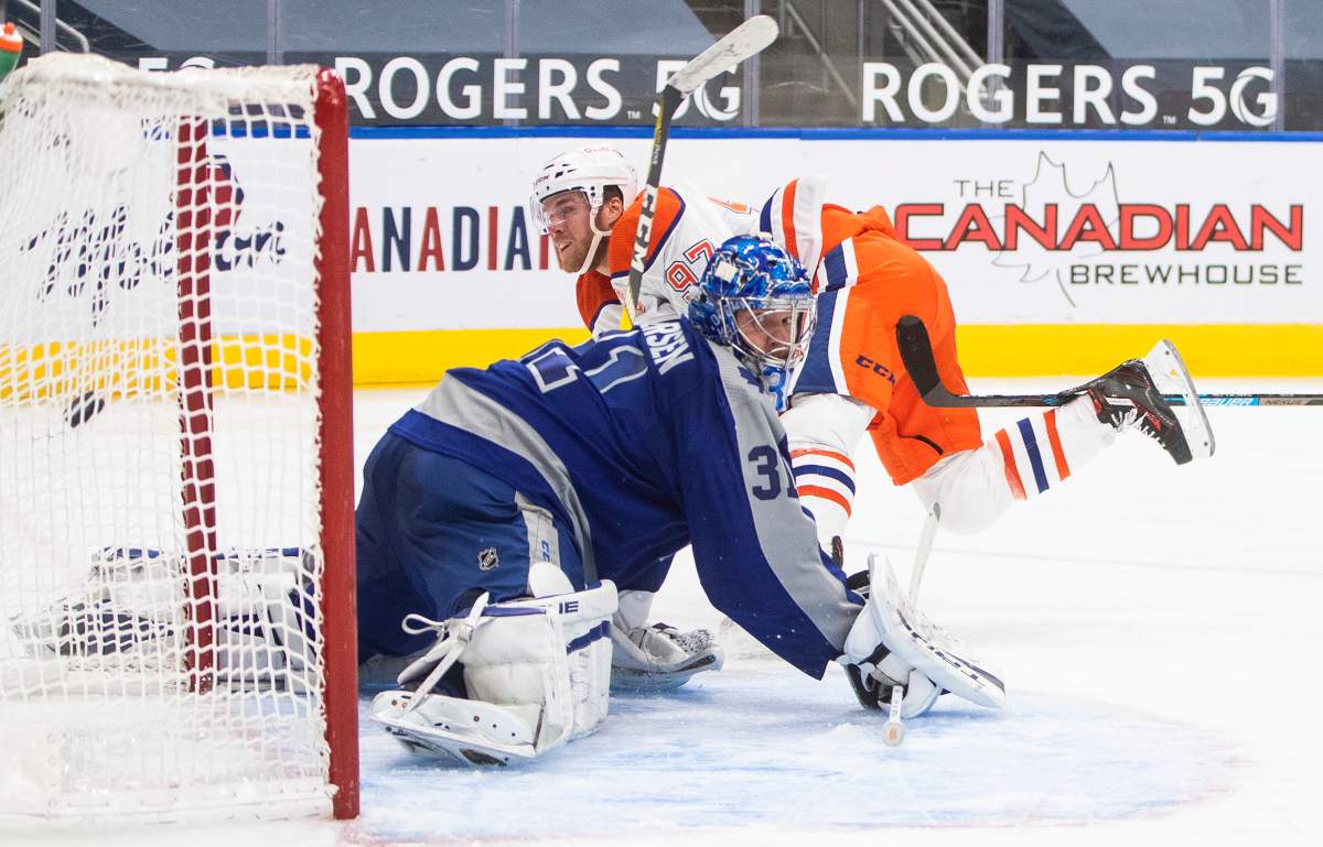 Edmonton Oilers' Connor McDavid (97) scores on Toronto Maple Leafs goalie Frederik Andersen (31) during second period NHL action in Edmonton on Saturday, January 30, 2021. THE CANADIAN PRESS/Jason Franson.
