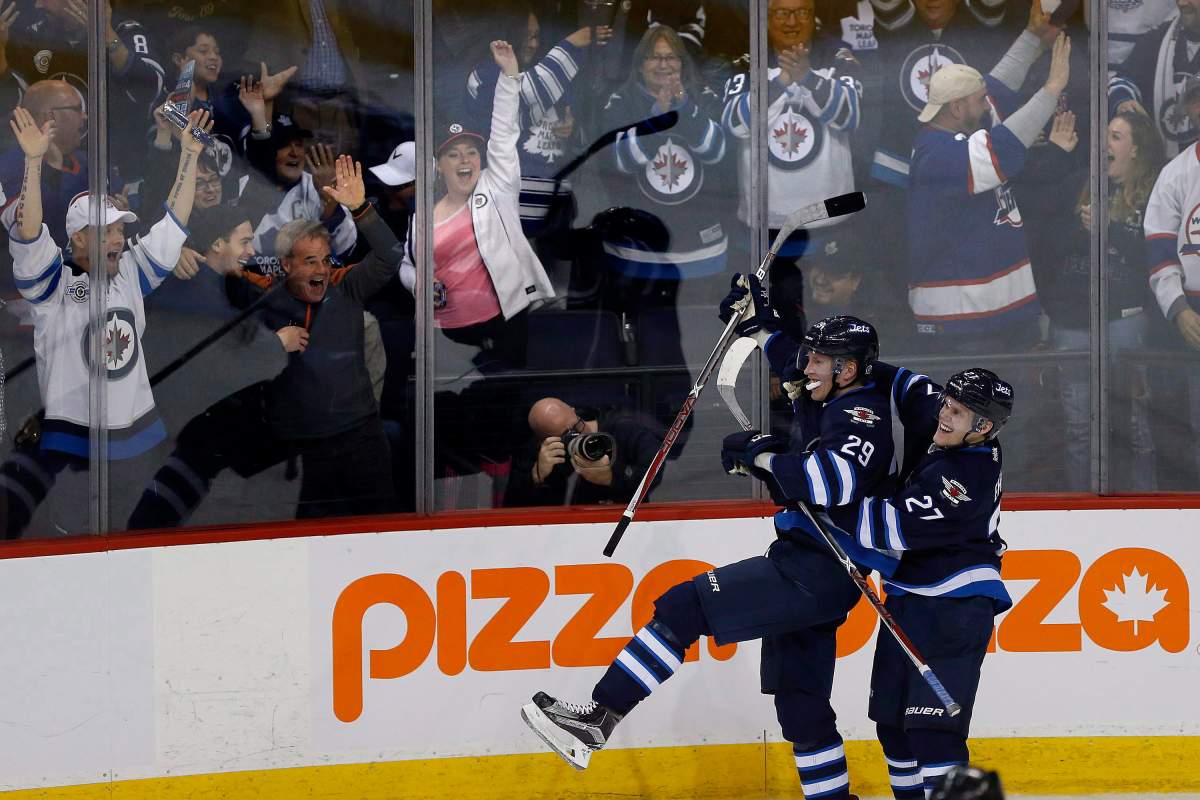 Winnipeg Jets’ Nikolaj Ehlers (27) and Patrik Laine (29) celebrate Patrik Laine’s (29) game-winning goal and hat-trick during overtime against the Toronto Maple Leafs in NHL action in Winnipeg on Wednesday, Oct. 19, 2016.