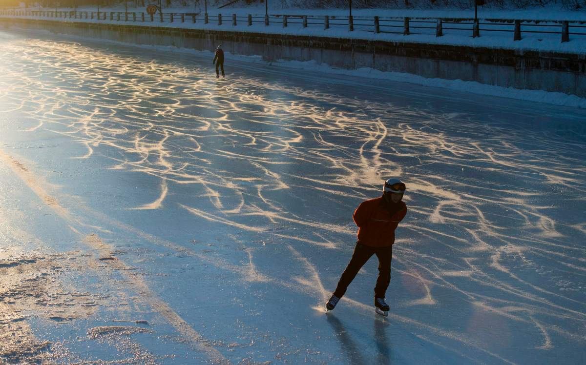 Skaters make their way along the Rideau Canal Skateway shortly after dawn on Sunday, Jan. 15, 2017 in Ottawa. The skateway will open for its 51st season "early next week," the NCC's chief executive said Thursday.