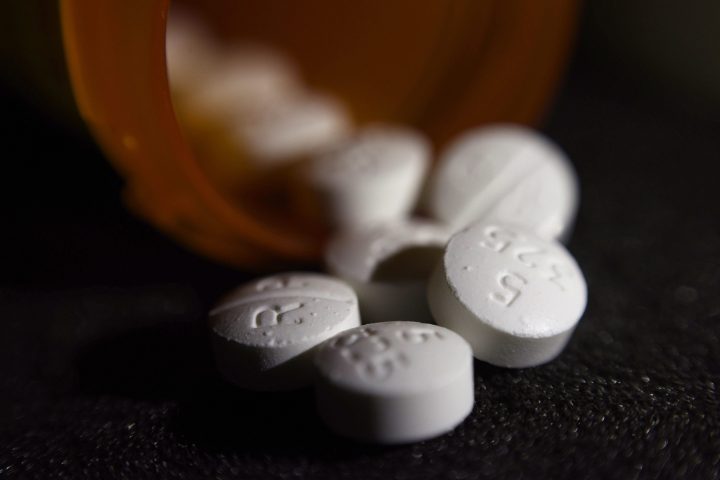 An arrangement of pills of the opioid oxycodone-acetaminophen .