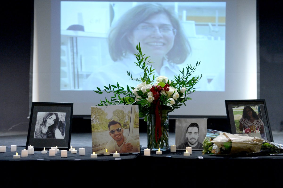 Photos of University of Ottawa students Alma Oladi, Saeed Kadkhodazadeh Kashani, and Mehraban Badiei Ardestani, stand on a table in front of a slideshow showing images of Ottawa area victims, during a memorial ceremony at the University of Ottawa to honour the three students who died in the crash of Ukraine International Airlines Flight PS752 in Tehran, on Friday, Jan. 10, 2020. 