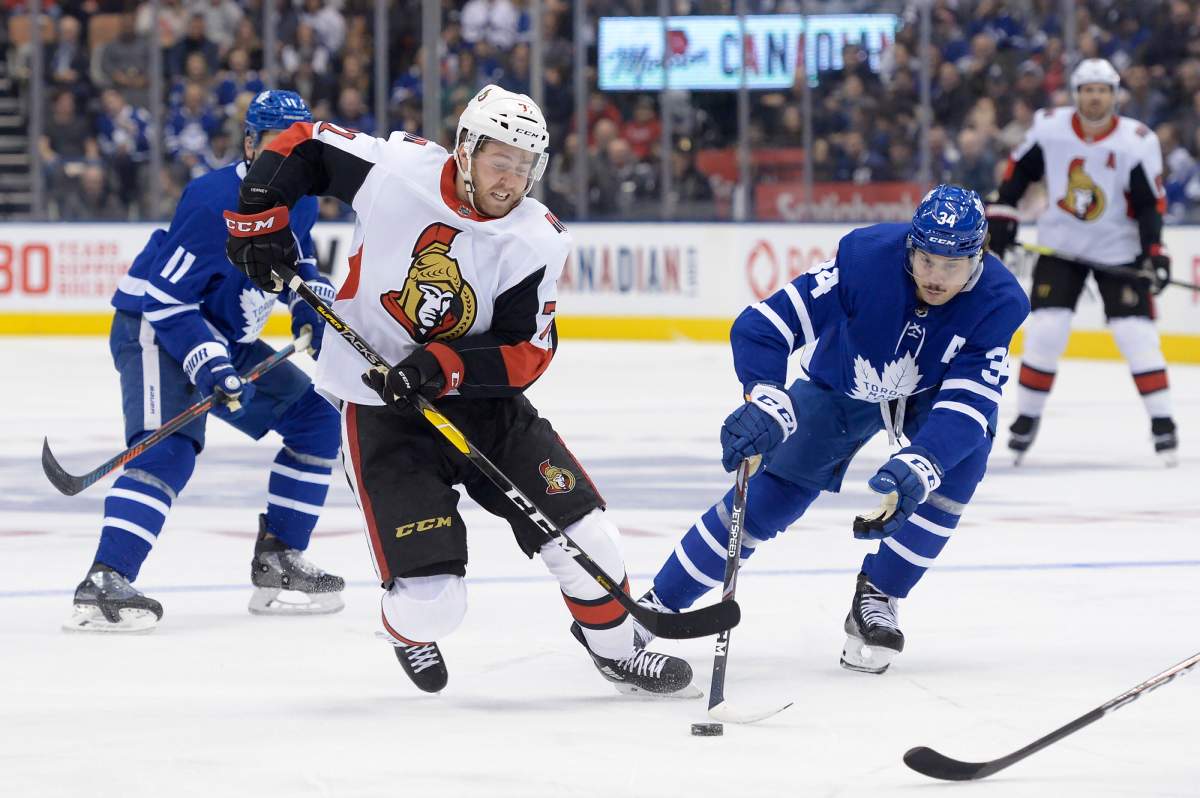 Ottawa Senators centre Chris Tierney (71) and Toronto Maple Leafs centre Auston Matthews (34) battle for the puck during first period NHL hockey action in Toronto, Saturday, Feb. 1, 2020.